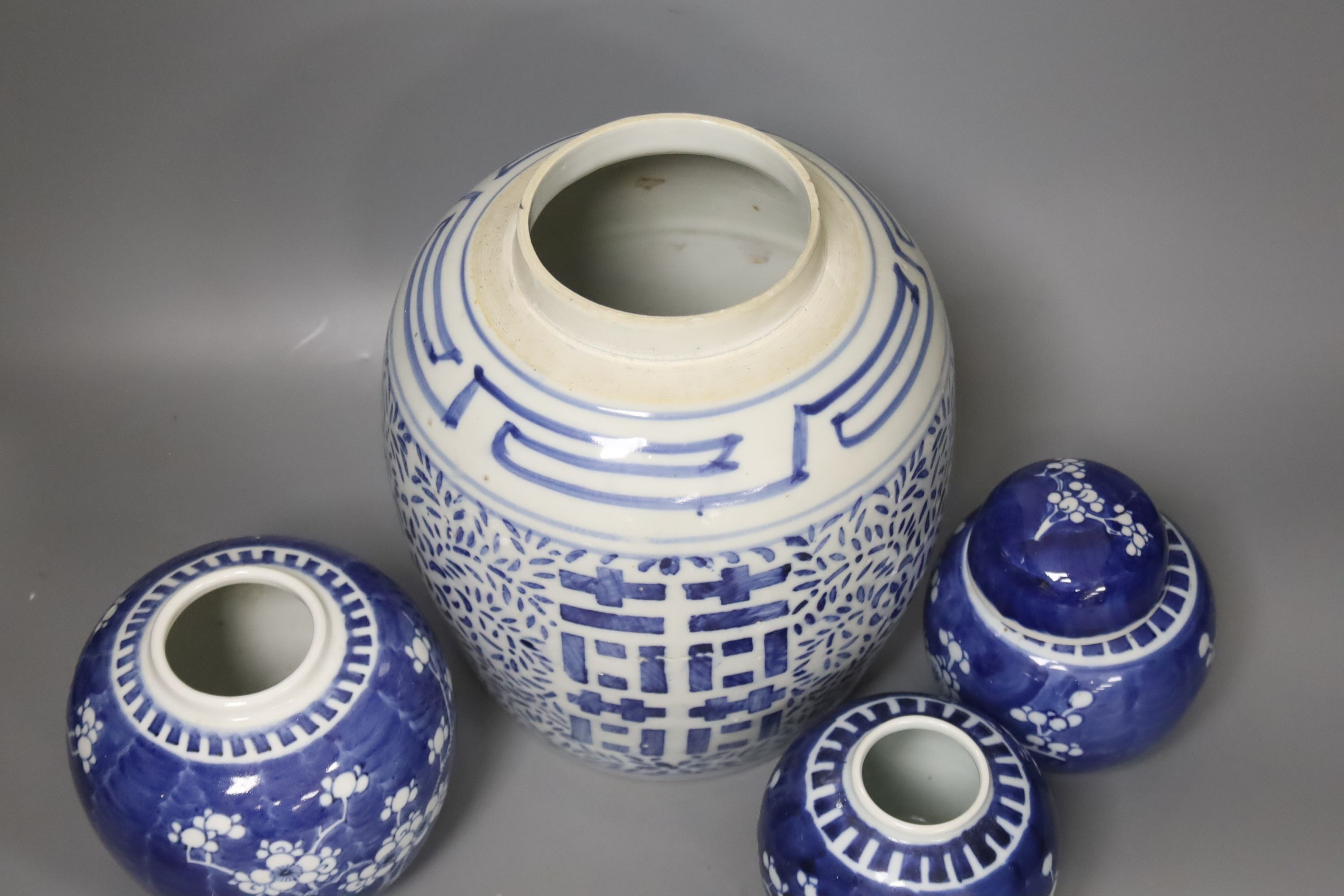 Four Chinese blue and white ginger jars, one with cover, tallest 23cm